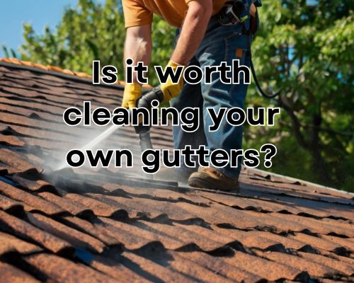 man using water pressure in cleaning the roof and gutters